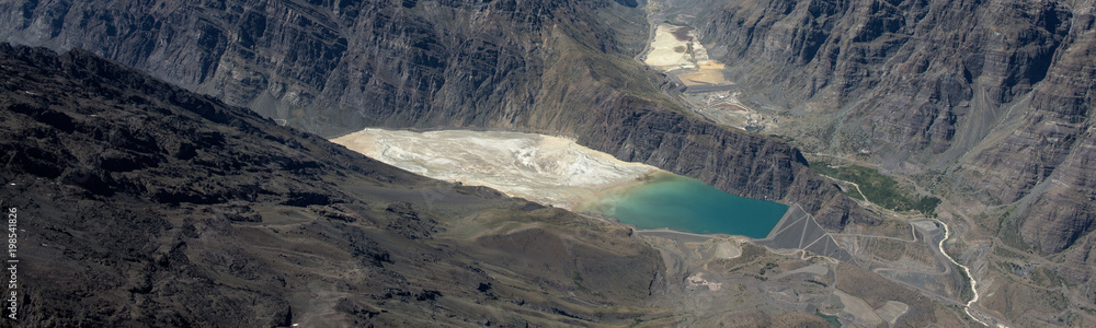 Aerial image of Los Leones Dam in the Cordillera de los Andes mountains in South America, from water coming from the Nevado del Plomo and the Los Leones and Blanco rivers