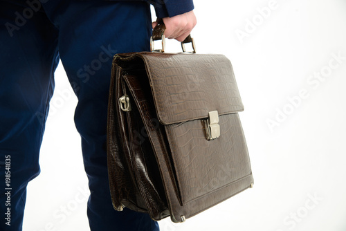 Close-up, hands of businessman holding briefcase isolated on white background,