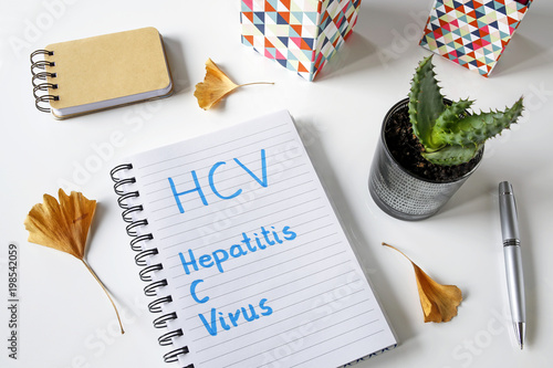 HCV Hepatitis C virus written in a notebook on white table photo