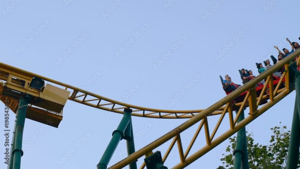 Roller coaster in an amusement park. Evening video footage in full hd format Roller coaster in an amusement park. Evening video footage in full hd format