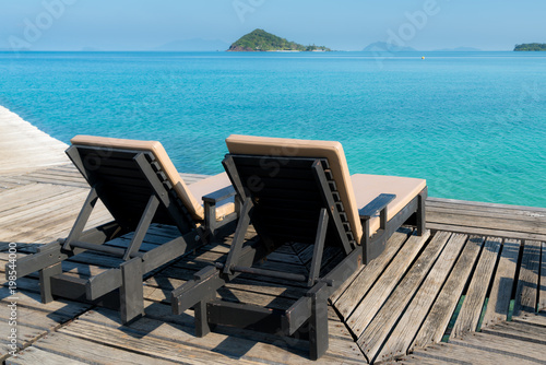 Perfect summer tropical paradise beach with lounge chairs at resort in Phuket, Thailand. Vacation summer holidays and travel concept.