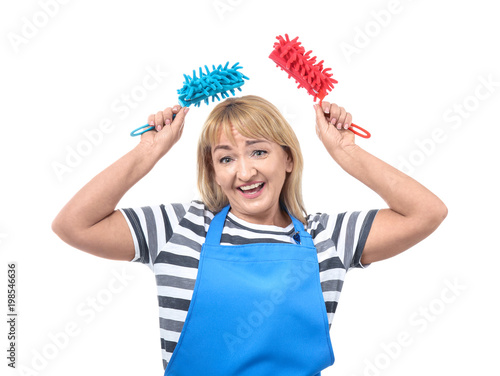 Portrait of mature woman in apron with fiber dusters on white background