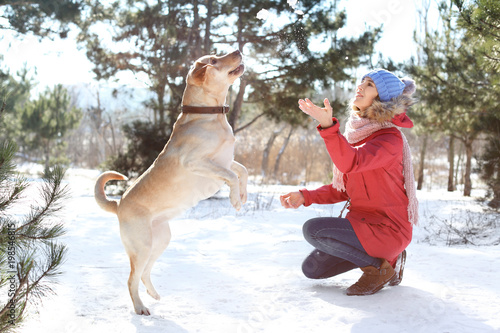 Woman playing with cute dog...