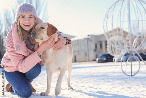 Woman with cute dog outdoor...