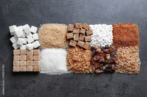 Flat lay composition with different types of sugar on gray background photo