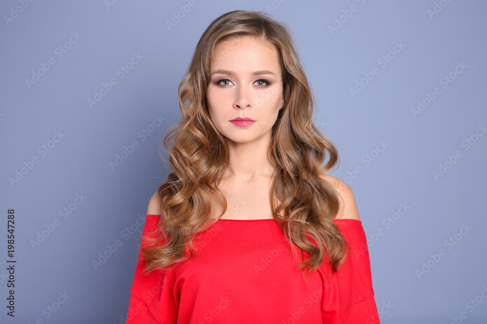 Portrait of young woman with long beautiful hair on grey background Portrait of young woman with long beautiful hair on grey background
