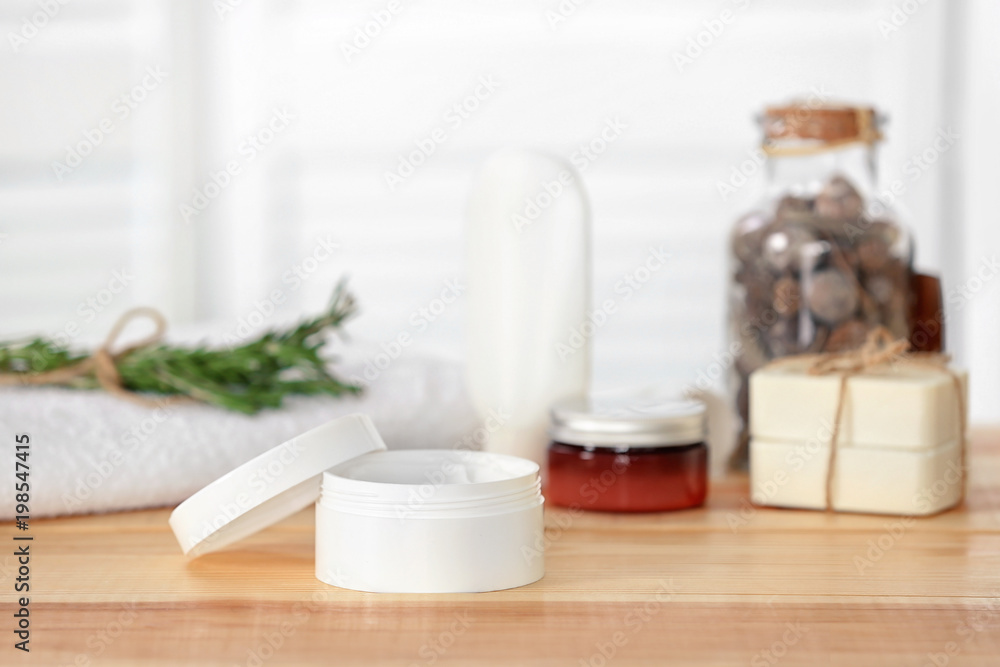 Jar with cream on wooden table. Body care cosmetics