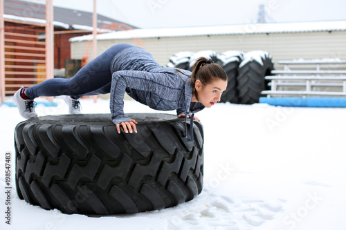 Young muscular woman traini...