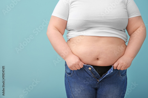 Overweight woman on color background © New Africa