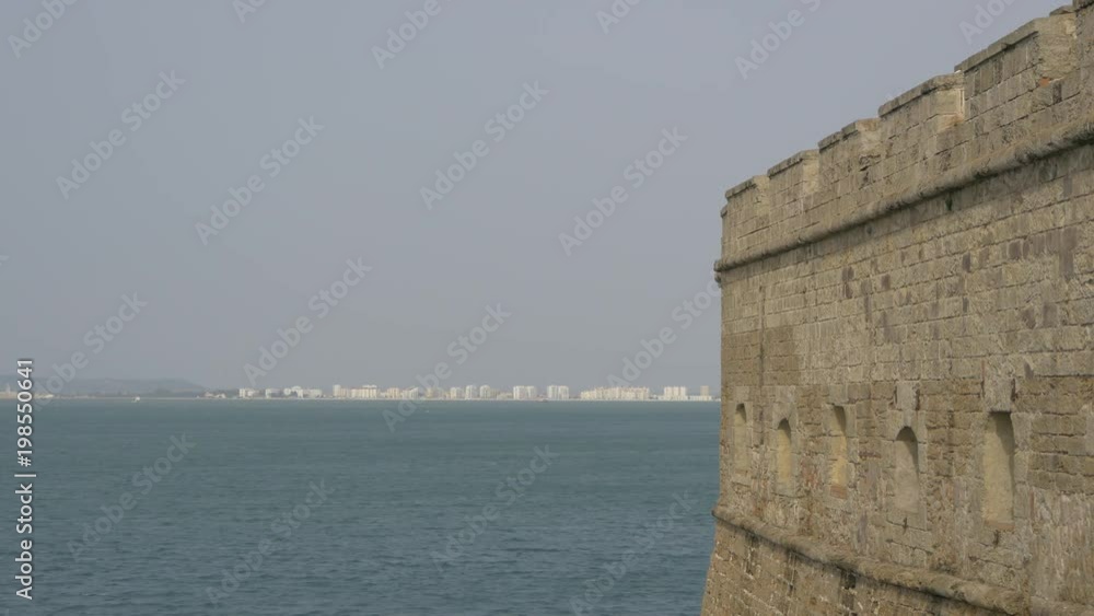 Buildings on a coastline seen from a brick wall Buildings on a coastline seen from a brick wall