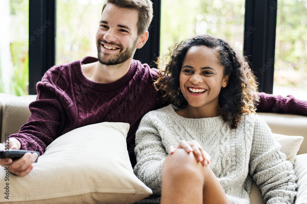 Couple watching a tv show together Couple watching a tv show together