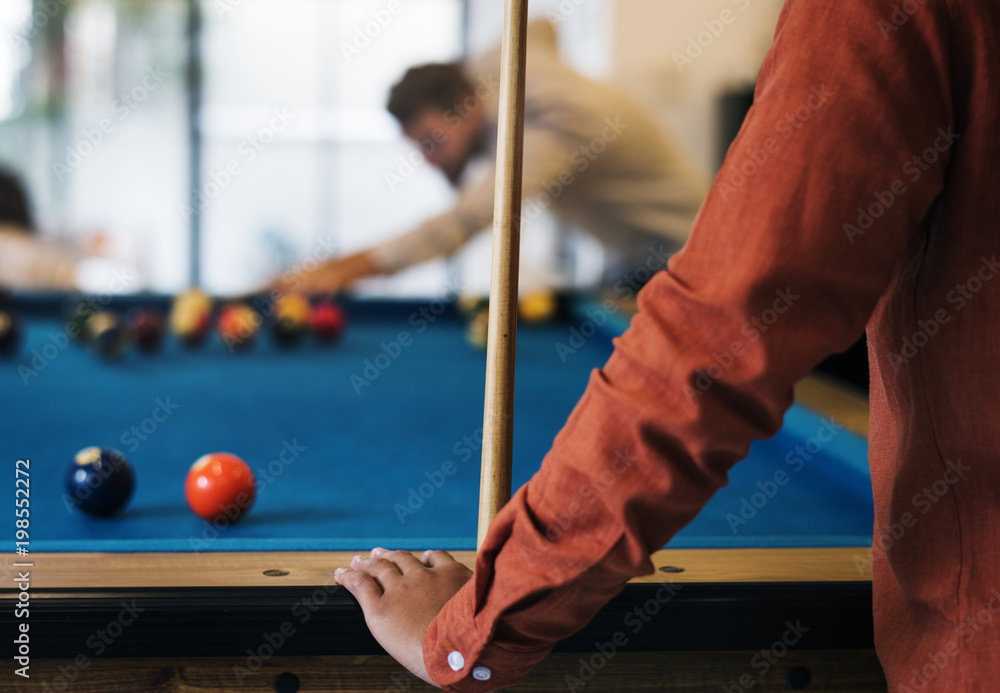 Happy friends playig pool together Happy friends playig pool together