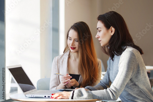 Two business women working at the office