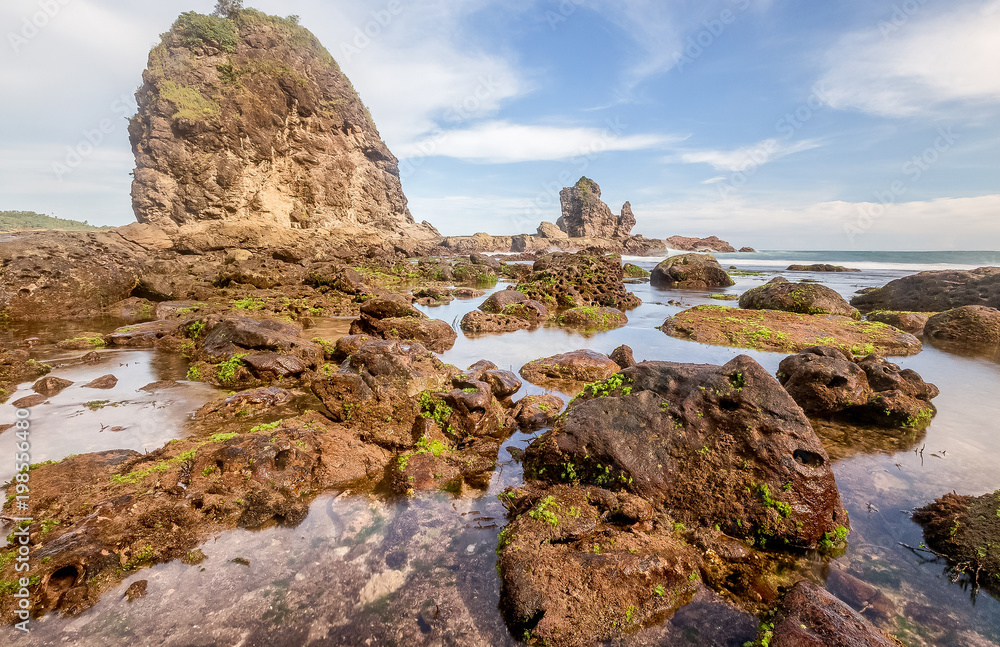 Amazing view of Yogyakarta seascape with natural coastal rock as foreground