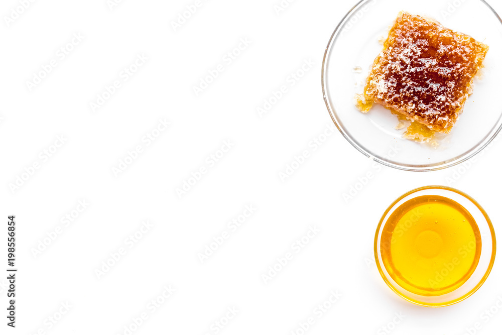 Honeycomb filled with honey on plate on white background top view space for text Honeycomb filled with honey on plate on white background top view space for text