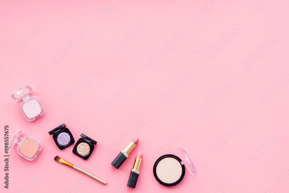 Women desk with decorative cosmetics for make up on pink background flat lay space for text Women desk with decorative cosmetics for make up on pink background flat lay space for text