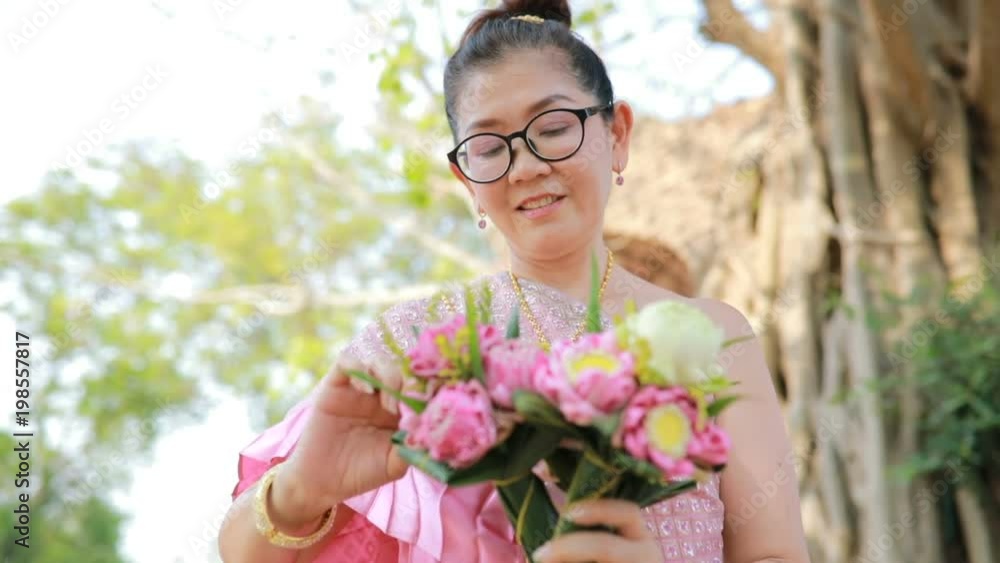 thai woman and tradition clothes with pink lotus in hand toothy smiling face thai woman and tradition clothes with pink lotus in hand toothy smiling face