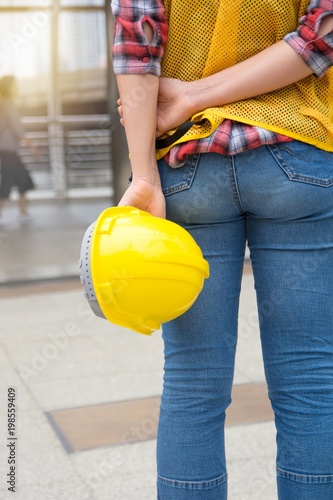 Back view of female architecture in front of construction site