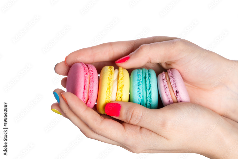 Female hand holding almond cookies on white background. Female hand holding almond cookies on white background.