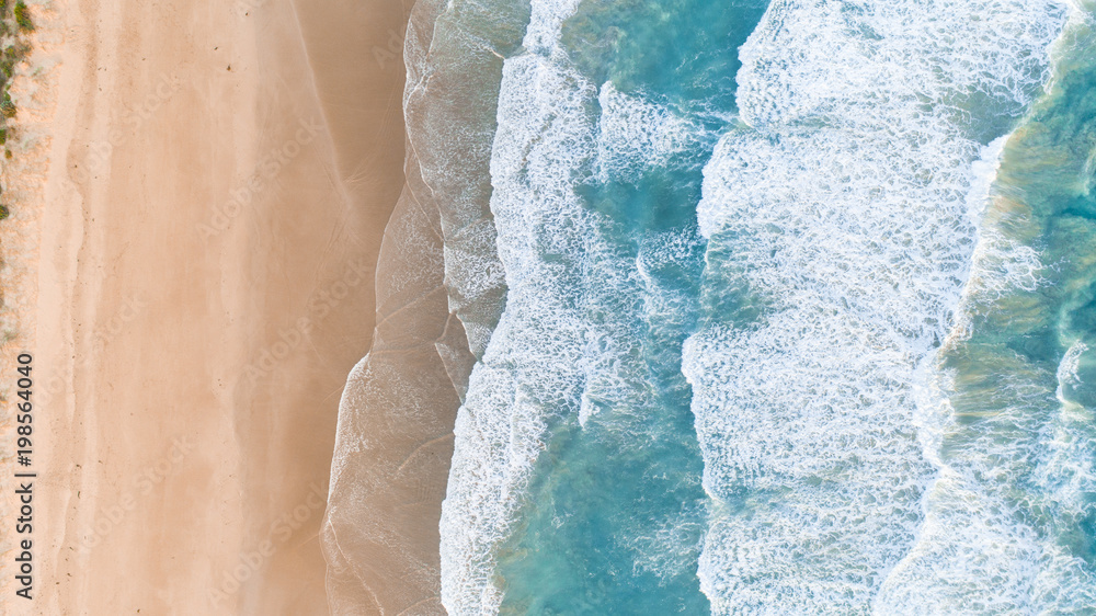 Aerial View of Waves at Beach at Sunset