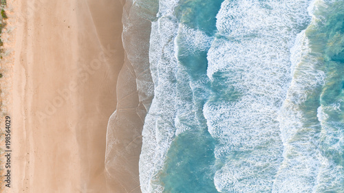 Aerial View of Waves at Beach at Sunset