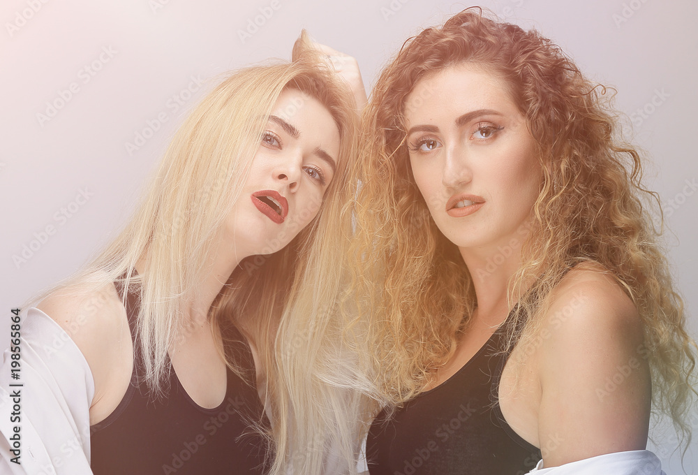two modern girls in black shirts. two modern girls in black shirts.