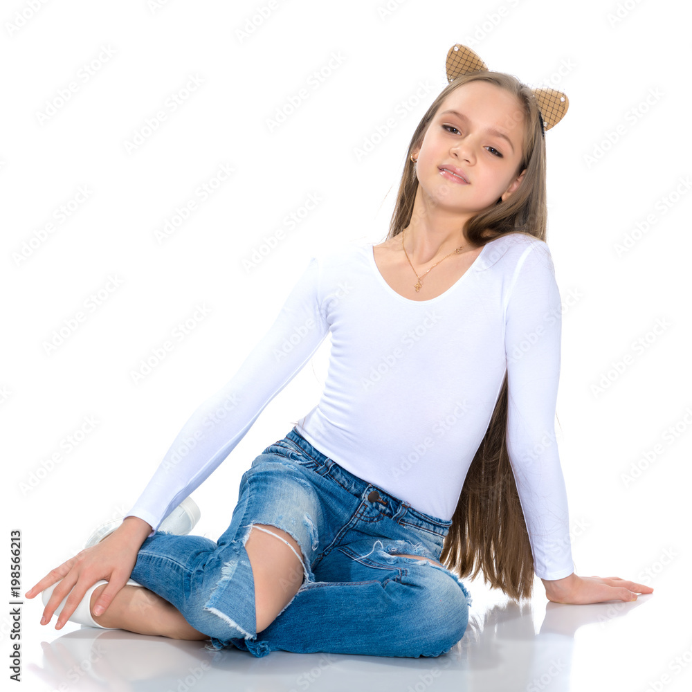 Beautiful teen girl in jeans with holes. Stock 写真 | Adobe Stock