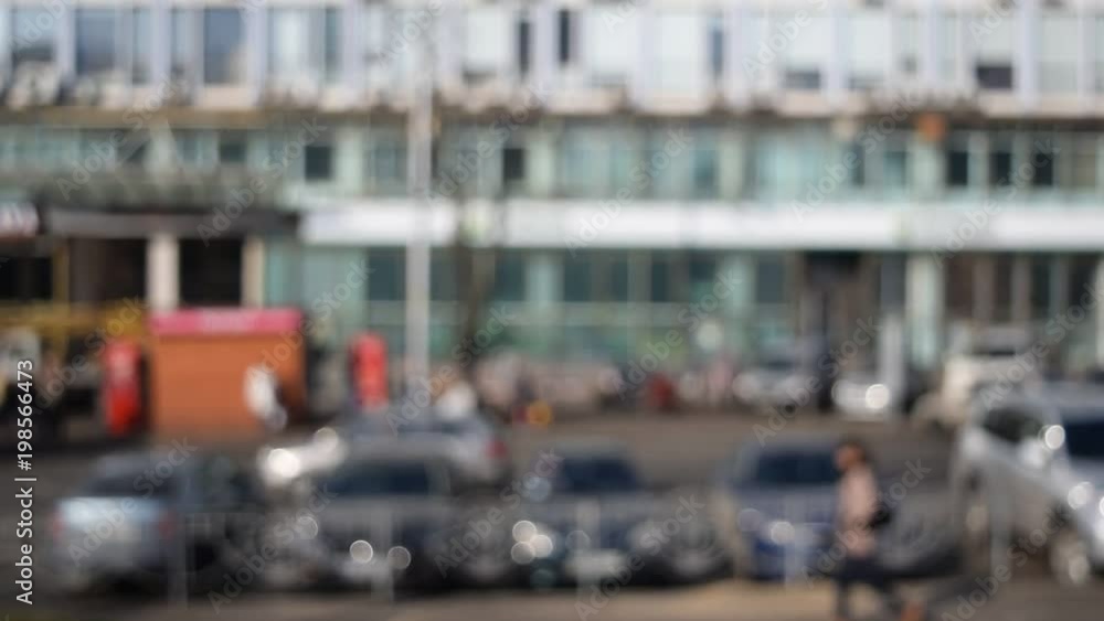 Unfocused view of a city with people and cars passing by Unfocused view of a city with people and cars passing by