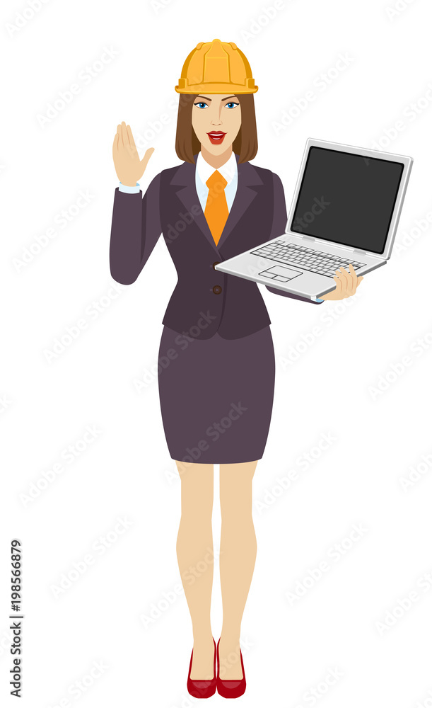 Businesswoman in construction helmet holding a laptop notebook and greeting someone with his hand raised up