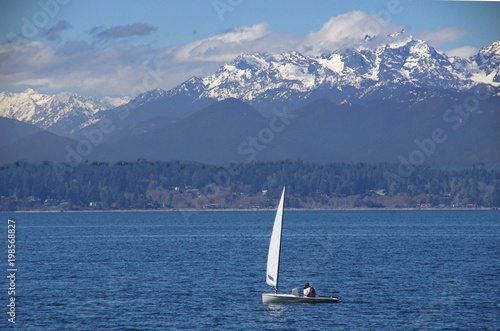 Sailboat on Puget Sound with Olympic mountains photo