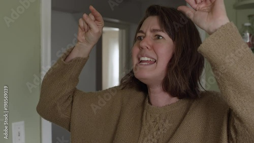 Close view of angry woman yelling with crazy look on her face.