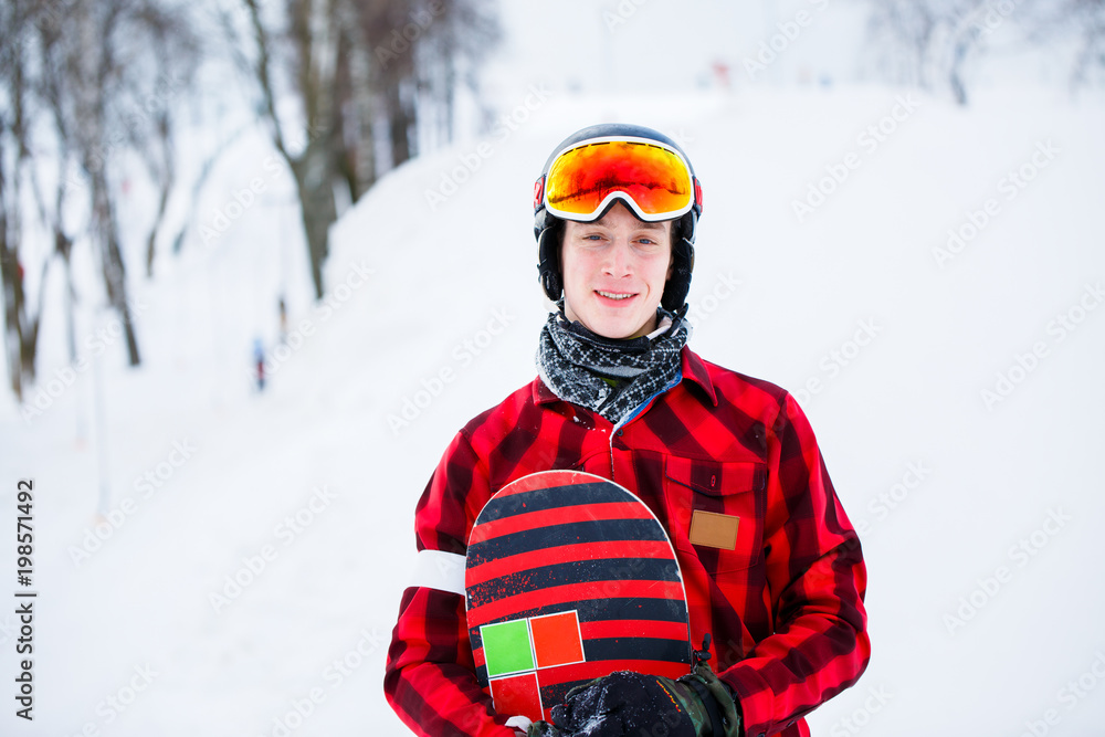 Photo of athlete in helmet with snowboard on blurred background Photo of athlete in helmet with snowboard on blurred background