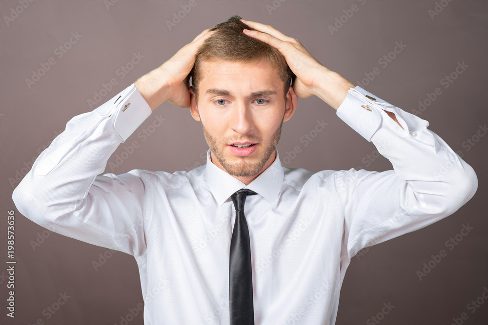 Confused young businessman thinking Confused young businessman thinking