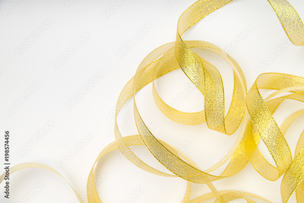 Shiny golden ribbon winded in spiral pattern on white background. Backdrop for text or announcement Shiny golden ribbon winded in spiral pattern on white background. Backdrop for text or announcement