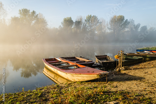 Wooden fishing boats moored on the lake shore 