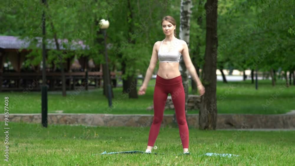 young girl doing yoga exercises in the park. He stretches, stretches. young girl doing yoga exercises in the park. He stretches, stretches.