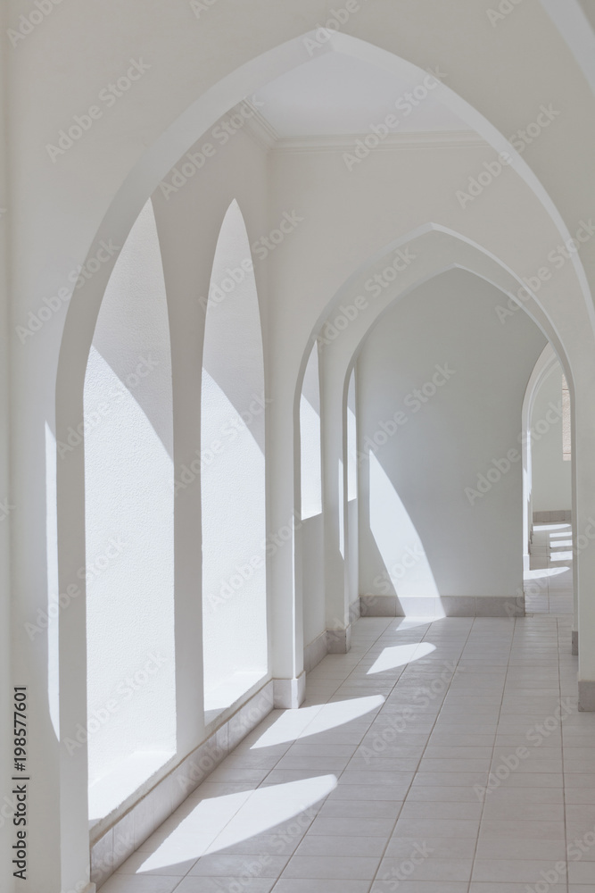 empty abstract light interior corridor background with arches and sunlight