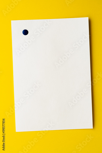 Empty white sheet is pinned to a yellow background