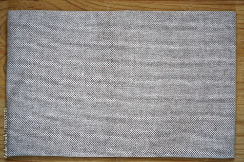 Linen fabric surface on wooden table for mock-up or designer use, book cover sample