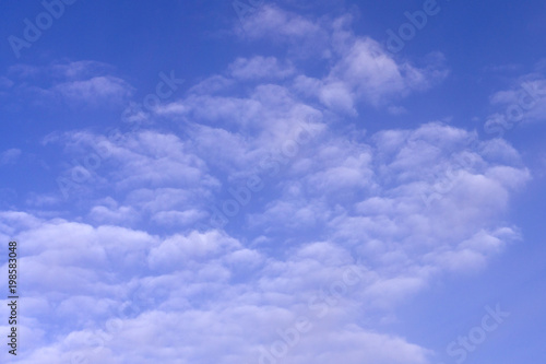 blue sky background with tiny clouds .