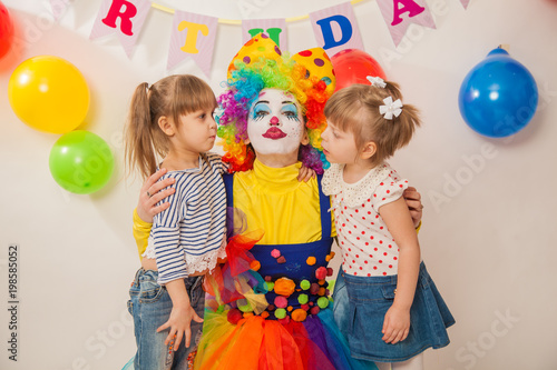 clown girl on the birthday of a child. Party for children. Clown with two little girls
