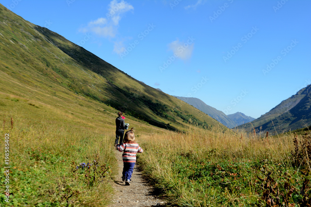 woman with child walking in the mountains