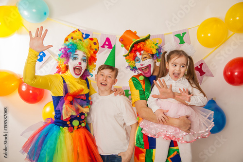 clown boy and clown girl at the birthday of brother and sister. Party for children. Clowns amuse children