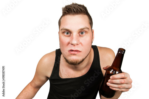 Drunk young morose alcoholic with a bottle of beer isolated on white.