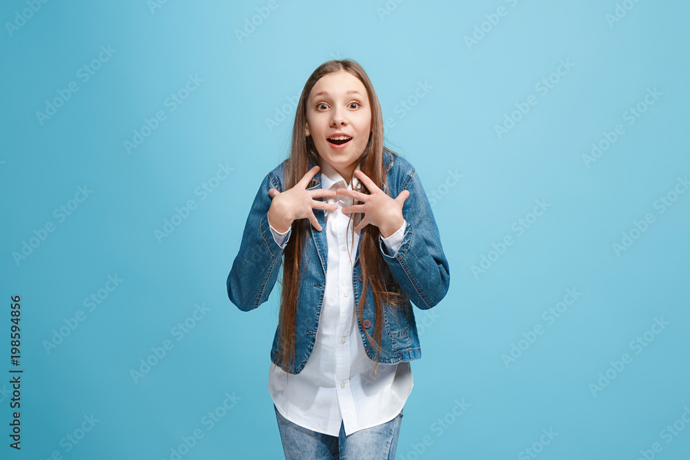 Beautiful teen girl looking suprised isolated on blue Beautiful teen girl looking suprised isolated on blue