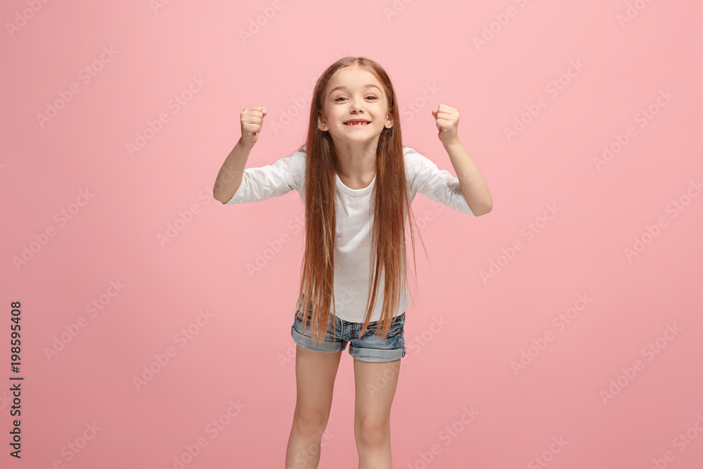 Happy success teen girl celebrating being a winner. Dynamic energetic image of female model Happy success teen girl celebrating being a winner. Dynamic energetic image of female model