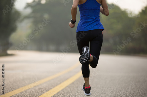 Fitness sportswoman running on trail