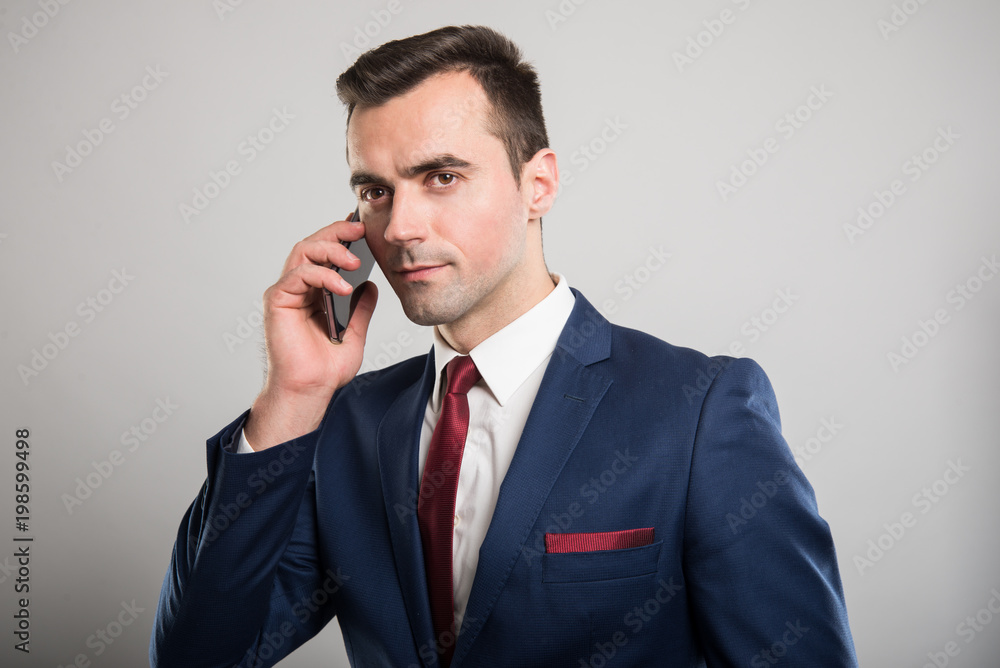 Attractive business man talking at smartphone Attractive business man talking at smartphone