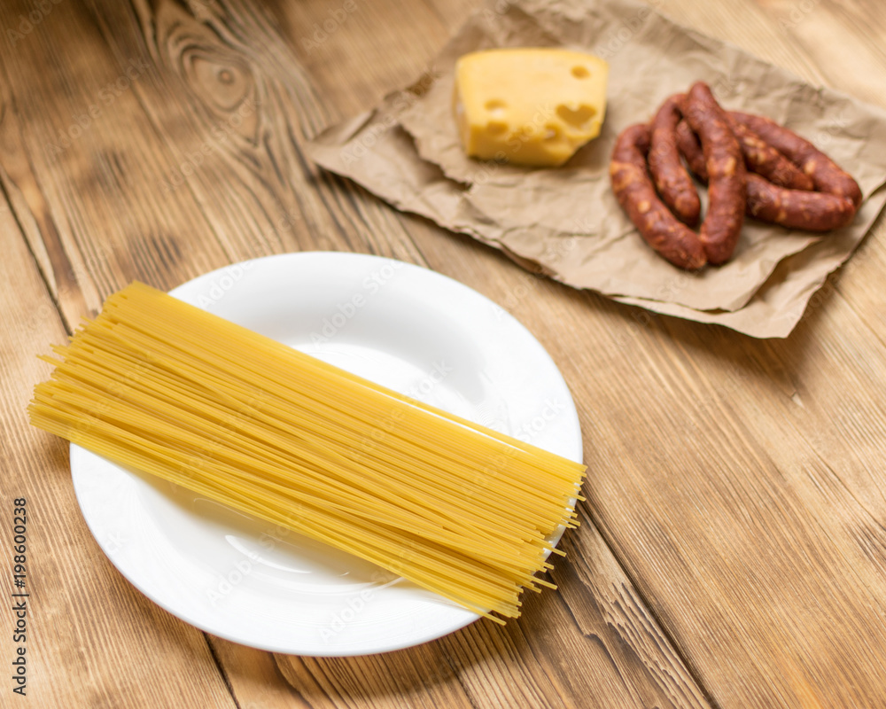Ingredients for Italian pasta. Raw spaghetti, ham, spices. Ingredients for Italian pasta. Raw spaghetti, ham, spices.