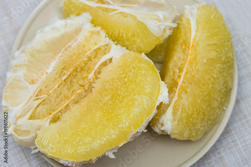 Purified pomelo lying in a plate photo